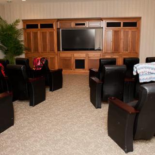 A cozy home theater setup with comfortable seating and a large screen.