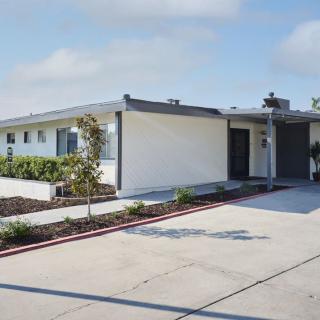 A modern residential house with clean lines and minimalistic landscaping.