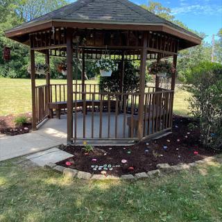 A beautiful wooden gazebo surrounded by greenery, perfect for enjoying the outdoors.