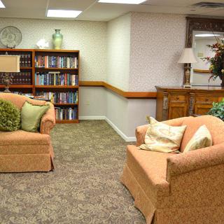 A cozy living room with a well-stocked bookshelf, comfortable couches, and stylish decor.