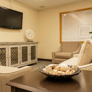 A cozy living room featuring a comfortable sofa, a TV, and decorative elements.