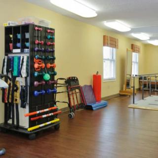 A well-equipped physical therapy room with various exercise equipment for rehabilitation and training.
