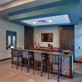 A modern bar area with seating and stylish decor.