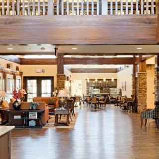 A spacious and welcoming lobby area with comfortable seating and wooden accents.