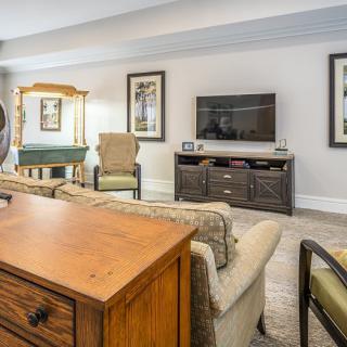 A cozy living room with comfortable seating, a television, and tasteful decor.