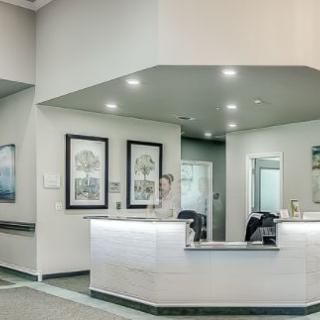 A modern reception desk area with contemporary decor and bright lighting.