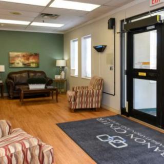 A well-furnished waiting room with comfortable seating and a welcoming atmosphere.