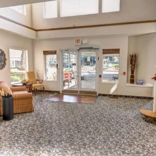 A bright lobby area with comfortable seating and large windows allowing natural light.