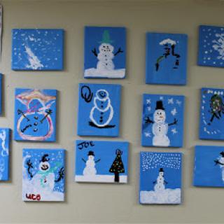 A collection of colorful snowman paintings on a blue background, creating a festive winter atmosphere.