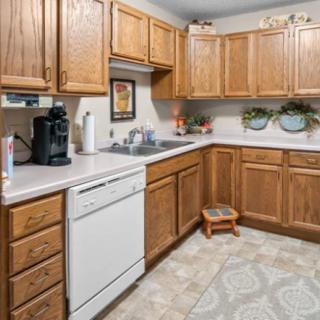 A cozy kitchen with wooden cabinets and modern appliances.