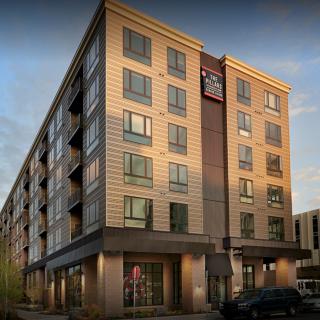A modern hotel building with multiple floors in an urban setting.