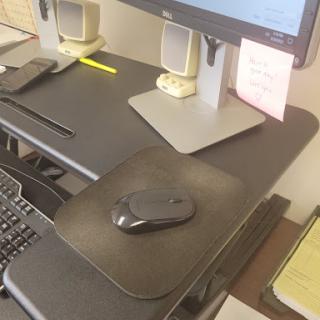 A well-organized office workspace featuring a computer setup with a mouse and keyboard.