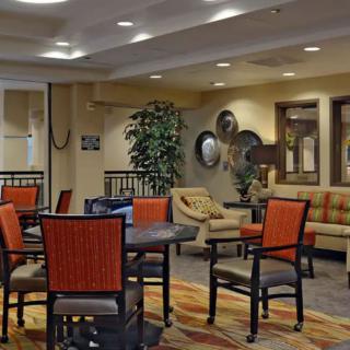 A cozy hotel lobby with comfortable seating and warm decor.
