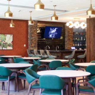 A modern restaurant interior featuring a bar area and stylish seating arrangements.