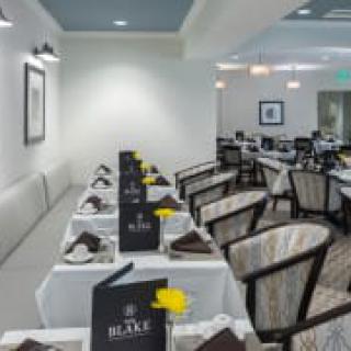 A neatly arranged dining area in a restaurant with tables set for service.