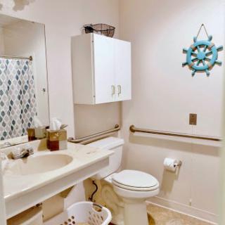 A clean and functional bathroom featuring modern fixtures and decorative elements.