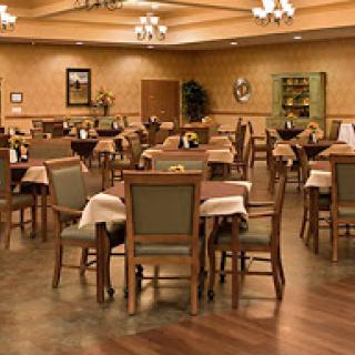 A spacious dining area with neatly arranged tables and chairs, ready to welcome guests.