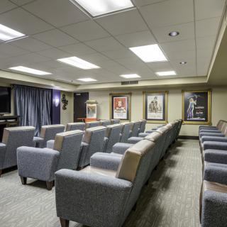 A well-designed home theater room with comfortable seating and movie posters on the walls.