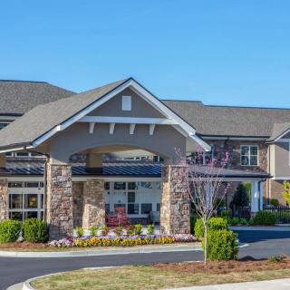 A view of a residential building with a landscaped entrance.