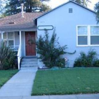 A suburban house with a neatly maintained front lawn.