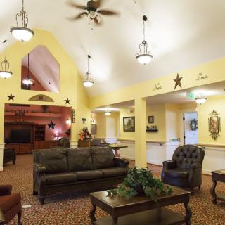 A cozy living room with comfortable seating and warm lighting.