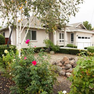 A charming residential home surrounded by a beautifully landscaped garden.