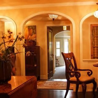 A warm and inviting living room with traditional decor and elegant archways.