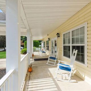 A sunny porch with rocking chairs and a cozy atmosphere.