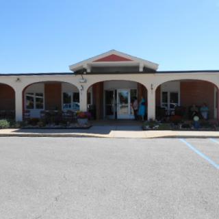 A welcoming entrance to a commercial building on a clear sunny day.