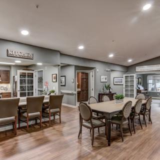 A modern dining and kitchen area with elegant furniture and decor.