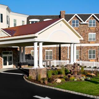 The exterior view of a hotel with a welcoming entrance and landscaped surroundings.