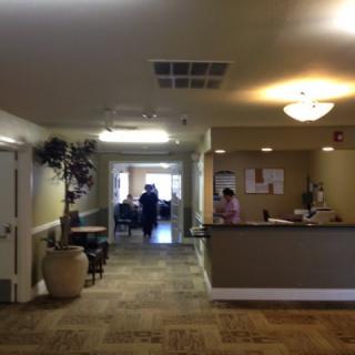 A reception area with a desk and seating in a well-lit lobby.