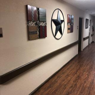 A cozy hallway adorned with stylish wall art and a wooden floor.