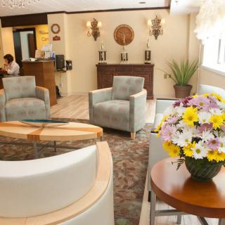 A cozy and elegantly decorated lobby with comfortable seating and floral arrangements.