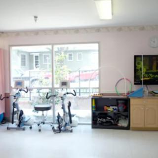 A bright indoor gym with exercise bikes and fitness equipment.