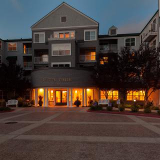 An illuminated apartment building entrance during the evening.