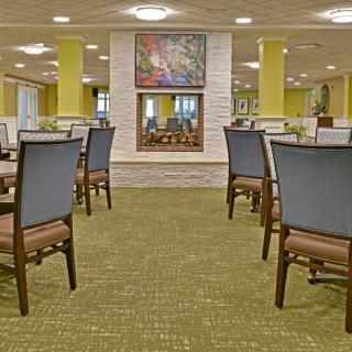 A modern dining area with neatly arranged tables and chairs.