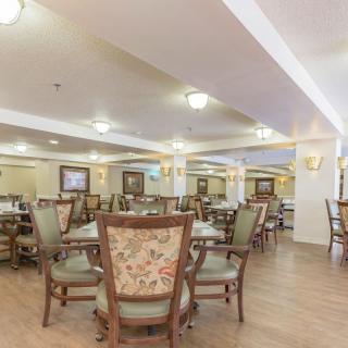 A spacious dining area with multiple tables and chairs arranged for seating.
