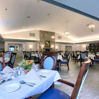 An elegant dining room with neatly arranged tables and chairs, ready for guests.