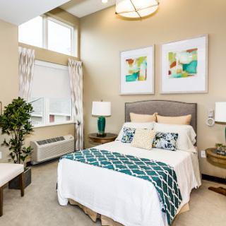 A beautifully designed modern bedroom featuring calming colors and stylish decor.