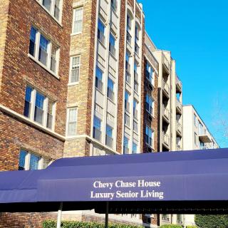 A luxury senior living building with a prominent awning reading 'Chevy Chase House Luxury Senior Living'.