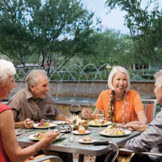 A group of friends enjoying a meal together outdoors.