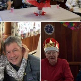Family gathering with everyone in a joyful mood, celebrating together indoors.