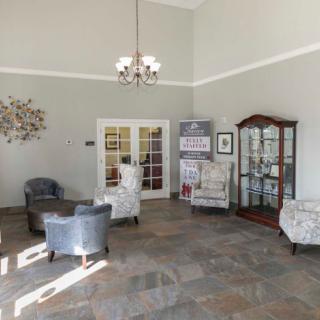 A cozy lobby area with comfortable seating, a chandelier, and decorative elements.