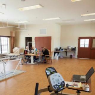 A rehabilitation room equipped with various exercise machines and therapy equipment.