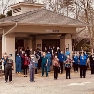 Healthcare workers come together to show unity and support outside the hospital.