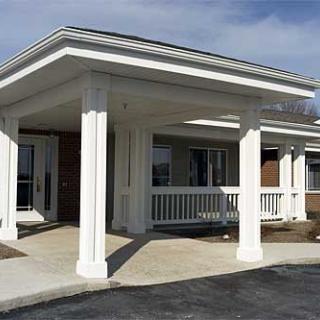 Entrance of a building featuring white columns and a covered porch.