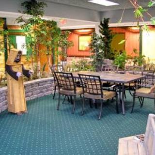 A cozy dining area featuring a table surrounded by chairs, complemented by indoor plants and decorative elements.