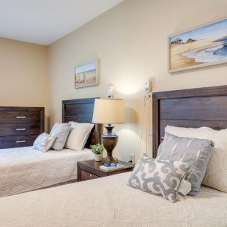 A cozy bedroom featuring twin beds with a modern decor and soft lighting.