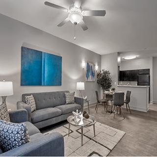A modern apartment living room with stylish decor and a cozy dining area.